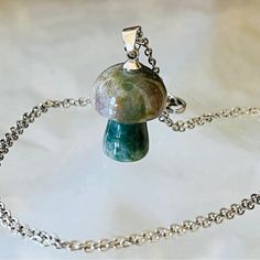 This Adorable Baby Mushroom Necklace Comes On An 18 Inch Stainless Steel Chain. It Measures 1 1/8 Inches Long And 5/8 Inches Wide At The Widest Point. I Will Include A Gift Box For You. Mushroom Crystal Necklace, Mini Mushroom, Mushroom Necklace, Fluorite Crystal, Adorable Baby, Christmas Wishlist, Steel Chain, Stainless Steel Chain, Green And Purple