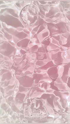 an abstract photo of water and bubbles in pink hued light blue, white and black