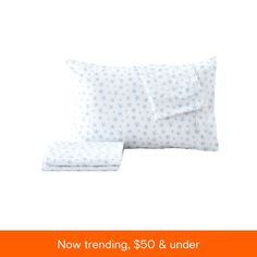 two pillows and one pillow case with the words now trending $ 50 & under