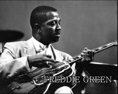 a black and white photo of a man playing a guitar