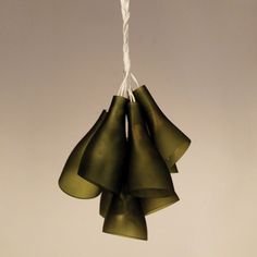 three green bells hanging from a white string