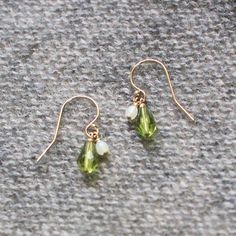 A lovely green teardrop and a little honeydew-colored bead are suspended from each 14k French gold-filled earwire on these sweet little earrings. Handmade in Seattle, WA.+ measures just over .75" from the top curve of the earwire to the base of the teardrop+ made with gold-filled earwires & glass beads+ packaged in a lovely small gift box tied with black ribbonLove purple jewelry? Shop more here: http://etsy.me/2thTQ4DLooking for more earrings? See more here: http://etsy.me/2thQnDc Green Teardrop Drop Earrings Nickel Free, Green Nickel-free Teardrop Drop Earrings, Green Nickel-free Teardrop Earrings, Green Teardrop Jewelry With Ear Wire, Green Pear-shaped Teardrop Earrings, Nickel-free Green Teardrop Pendant Earrings, Everyday Green Teardrop Pendant Jewelry, Green Pearl Drop Jewelry, Green Teardrop Earrings For May Birthstone