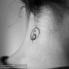 a woman's neck with a small tattoo on it