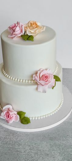 2 tier white rolled fondant wedding cake Anniversary Cake Two Tier, Two Tier Fondant Cake, Wedding Cake Designs Simple 2 Tier, 2 Tier Birthday Cake For Women, 2 Tier Floral Cake, 2 Tier Cake Ideas, Simple Wedding Cake 2 Tier, Communion Desserts, White Fondant Wedding Cake