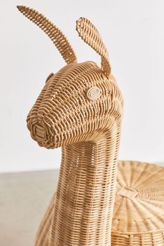 an animal made out of wicker sitting on top of a table