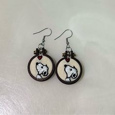 a pair of earrings with a bear on it