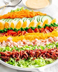 a platter filled with meat, cheese and veggies