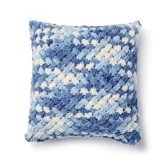 a blue and white pillow on a white background