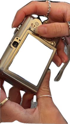 a person holding a small device in their hand with a chain around it's wrist