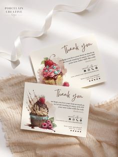 two thank you cards with cupcakes and strawberries on them sitting next to each other