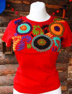 "Mexican embroidered shirt Beautiful embroidered blouse. This is handmade in Mexico. Perfect for those summer days at the beach, or for your fiesta parties. The embroidery colors may vary due all the handmade work (not the design). If you want an specific color, please send us a message so we can send you the ones available so you can choose. Size: Extra Small: 13\" width x 22\" long Small; 14\" width x 23\" long Medium: 15 1/2\" width x 24\" long (Width: shoulder - shoulder) Please also notice Bohemian Red Cotton T-shirt, Bohemian Embroidered Summer T-shirt, Multicolor Floral Embroidery T-shirt For Summer, Red Cotton Shirt With Floral Embroidery, Bohemian Shirt With Multicolor Embroidery, Embroidered Short Sleeve Beach Shirt, Embroidered Short Sleeve Shirt For Beach, Multicolor Embroidered Crew Neck Top For Summer, Red Embroidered Tops For Festivals