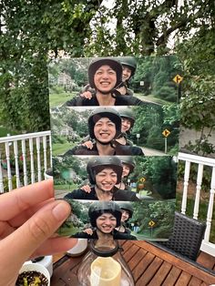 a person holding up a card with pictures of people on it