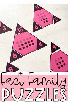 some pink and black dices with the words fact family puzzles