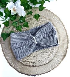 a knitted bow tie sitting on top of a wicker plate