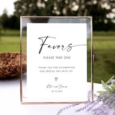 a sign that says favors on it next to some purple flowers and a basket in the background