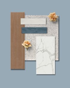 an assortment of marble and wood materials on a blue background with flowers in the corner