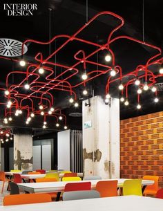 an empty restaurant with red and yellow chairs