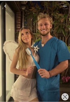 a man and woman dressed up in costumes posing for a photo with a toothbrush