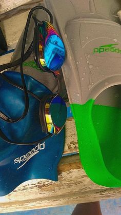 a pair of sunglasses sitting on top of a blue and green object next to other items