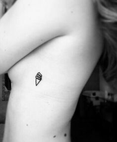 a black and white photo of a woman's arm with an ice cream cone tattoo on it