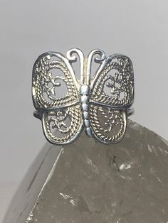 "Butterfly ring filigree band sterling silver women girls Size 6.75 Weight 3.4g Widest part 3/4\" Thinnest part 1/8\" Free Shipping & Free Postal Insurance Delivered in a Gift Box If you do not want the ring polished and want to leave the natural patina please let me know at the time of purchase as I do polish rings before I ship rings out. Thanks Free First Class shipping and postal insurance is included. If you want to upgrade to priority kindly pay an additional fee to do so. This is recommen Adjustable Silver Vintage Filigree Ring, Silver Sterling Filigree Ring With Intricate Design, Silver Filigree Open Ring, Sterling Silver Filigree Toe Ring, Sterling Silver Filigree Ring With Decorative Band As Gift, Ornate Filigree Ring For Promise, Adjustable Sterling Silver Butterfly Ring For Anniversary, Ornate Adjustable Sterling Silver Filigree Ring, Adjustable Ornate Sterling Silver Filigree Ring