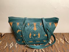 Leaders In Leather, Rare Find Old Stash,New, Never Used, Tag Still On. Beautifully Cutout, Tooled Shoulder Bag, Excellent quality, and Classic, Boho Chic Western Color: Turquoise/Beige, Bold and chic, accents the wardrobe with style Eye catching, definitely one of my, on-the-go bags, This Bag has much Style and Lots of room. Check out the photos for a visual description. I love a wide top for a bag, Easy to find things. Shoulder Bag Straps length 14 1/2"  Shoulder Bag inside small side pocket w/Zipper Shoulder Bag Top Zipper 16"  Shoulder Bag height 11" Bag Bottom width 7" Bag Bottom Length 14" Inside Lined with Beautiful Signature Gold and Black Fabric, Credit Card Slots, and a Pen Slot. Box # 7 About: Leaders In Leather, LEADERS IN LEATHER was founded in 1993 in Austin, Texas by Chilean- Turquoise Hand Tooled Shoulder Bag For Everyday Use, Hand Tooled Turquoise Shoulder Bag For Everyday Use, Turquoise Hand Tooled Bags For Everyday Use, Hand Tooled Turquoise Bag For Everyday Use, Turquoise Hand Tooled Everyday Bags, Turquoise Hand Tooled Rectangular Shoulder Bag, Turquoise Hand Tooled Shoulder Bag For Travel, Turquoise Hand Tooled Travel Bag, Green Hand Tooled Bag For Daily Use