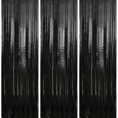 three black and white curtains are hanging in front of a wall with trees on it