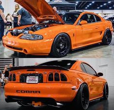 an orange car with the hood open and people looking at it