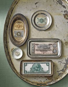 an old metal plate with different types of money on it