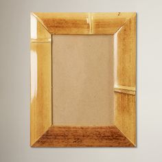 an empty wooden frame hanging on the wall