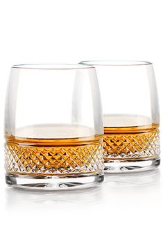 two whiskey glasses sitting next to each other