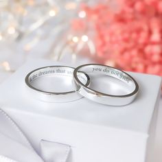 two wedding rings sitting on top of a white box with the words, you dream that never ends