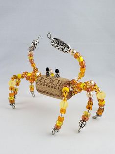 a crab made out of wine corks with beads on it's legs and feet