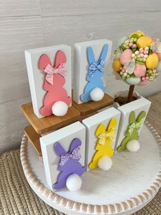 easter decorations are displayed on small wooden blocks