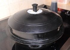 a large black pot sitting on top of a stove