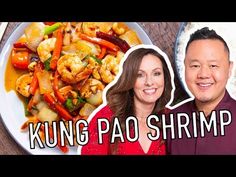 a man and woman standing next to a plate of food