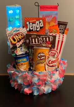 a basket filled with candy and snacks on top of a table