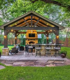 an outdoor kitchen and grill area in the backyard