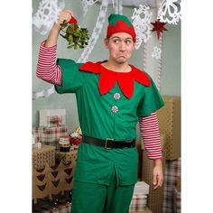 a man dressed in an elf costume holding a christmas decoration