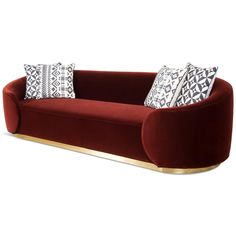 a red couch with pillows on top of it