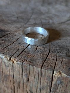 This ring is a solid, made for everyday use ring.  There are multiple sizes available, each ring will be slightly different in terms of texture.  Made of heavy gauge Sterling silver, with a hammered satin finish Hammered Wide Band Rings For Everyday, Hammered Sterling Silver Wide Band Ring, Sterling Silver Wide Band Hammered Rings, Hammered Wide Band Sterling Silver Ring, Hand Forged Sterling Silver Rings With Thick Band, Hammered Wide Band Ring For Promise, Hammered Thick Band Wide Ring For Promise, Classic Sterling Silver Hammered Ring, Hand Forged Silver Ring With Thick Band