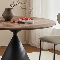 a table with two chairs and a vase on it