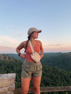 a woman standing on top of a cliff