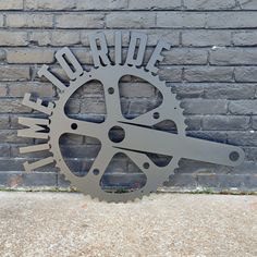 a metal clock on the side of a brick wall