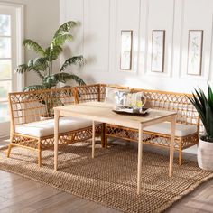 a wooden table sitting on top of a rug in a living room next to a potted plant