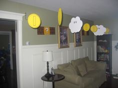 a living room filled with furniture and pictures hanging on the wall above it's head