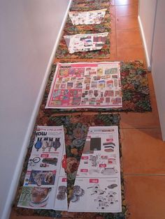 three newspapers laying on the ground next to each other in front of a door way