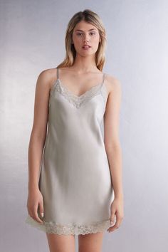 Wrap yourself in the timeless elegance of our silk and lace slip, crafted to elevate your loungewear with refined sophistication. This lacey slip combines the luxury of pure silk with delicate lace, creating a look that is both classic and endlessly stylish. This timeless slip is perfect for those moments when you want to feel opulent yet comfortable. Made from premium-quality, ultra-smooth silk, this slip offers a naturally soft touch that drapes beautifully against the skin. With its durable a Elegant Spring Sleep Camisole, Elegant Lace Trim Cami Slip Dress, Elegant Cami Slip Dress With Lace Trim, Elegant Lace Camisole For Loungewear, Elegant Camisole With Delicate Lace And Spaghetti Straps, Elegant Cami Slip Dress With Delicate Lace, Elegant Lace Camisole For Daywear, Elegant Delicate Lace Camisole For Daywear, Elegant Daywear Camisole With Delicate Lace