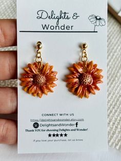 Welcome the warmth of fall with our handcrafted Sunflower Clay Earrings. Sunflowers, Strawflowers and Leaves; these exquisite pieces combine the rich hues of golden and copper to capture the essence of autumn. Perfectly designed for both casual outings and elegant evenings, these earrings add a touch of nature-inspired beauty to any ensemble. 🌻Features: - Handcrafted Design: Each pair is meticulously crafted from high-quality polymer clay, ensuring unique and durable pieces. - Elegant Shimmer o Bohemian Sunflower Design Flower Earrings As Gift, Brown Flower-shaped Jewelry Gift, Nature-inspired Brown Flower-shaped Jewelry, Brown Flower Shaped Earrings For Gift, Brown Flower-shaped Earrings For Gift, Orange Flower-shaped Earrings For Gift, Orange Flower-shaped Adjustable Earrings, Vintage Brown Flower Earrings, Handmade Orange Flower Earrings