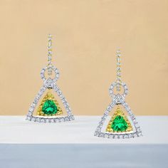 These earrings are gorgeous and stunning! Two trillion cut tsavorite garnets are set with round brilliant-cut diamonds and bright yellow sapphires. The garnets are a beautiful, brilliant grass-green color. The yellow sapphires and diamonds compliment and contrast with the green garnets and add even more sparkle. They are made of 18k white and yellow gold by our Master Jewelers in Los Angeles. Tsavorite garnets, 4.00 millimeters, .67 carat total118 round brilliant cut diamonds, .95 carat total36 round cut yellow sapphires, .18 carat total Green Diamond Drop Earrings With Accents, Luxury Green Diamond Earrings With Accents, Green Brilliant Cut Diamond Earrings, Green Diamond Earrings Fine Jewelry, Green Diamond Earrings In Fine Jewelry Style, Formal Tsavorite Earrings Fine Jewelry, Green Pave Setting Fine Earrings, Green Gemstone Diamond Earrings, Green Brilliant-cut Earrings For May Birthstone